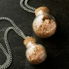 Found Objects™ Clear Round Bottle Pendants by Bead Landing™