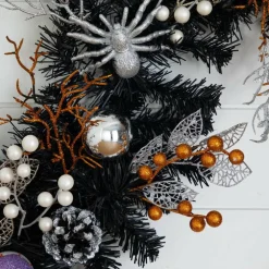 6ft. Artificial Halloween Black Garland with Skulls, Eyeballs & Spiders