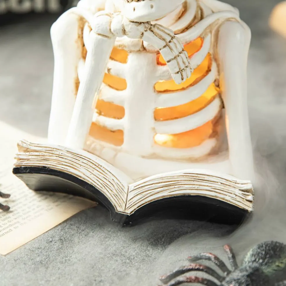 Glitzhome® 10" Lighted Halloween Resin Skull Reading Book Table Décor
