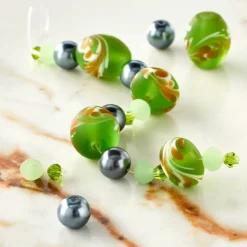 12 Pack: Green Lampwork Glass Swirl Rondelle & Oval Beads by Bead Landing™