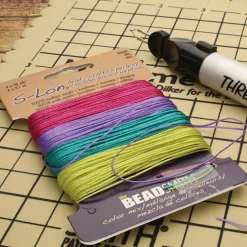 12 Packs: 4 ct. (48 total) The Beadsmith® S-Lon® 0.5mm Mixed Color Bead Cords