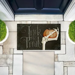 Stupell Industries Trick Or Treat Skeleton Hand Printed Outdoor Door Mat, design by Nicole Tamarin, 18"x30"
